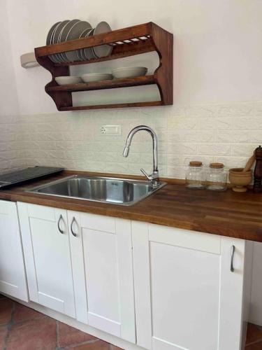 a kitchen with a sink and a wooden counter top at iL VICOLO NEL VERDE in Rio Marina