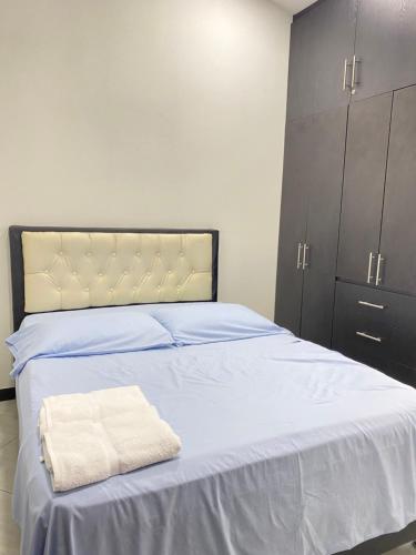 a bedroom with a bed with two towels on it at casa vacacional en Anapoima in Anapoima