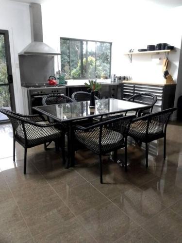 a table and chairs in a kitchen with a stove at Kaba Kada House - Daintree Rainforest in Diwan