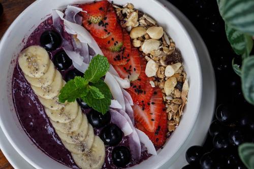 a bowl of food with fruit and nuts at Unagi Wooden Villas by Emana in Ubud