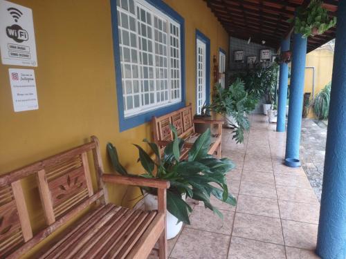 a group of benches sitting next to a building at Chácara em Itu Tomorrowland in Itu