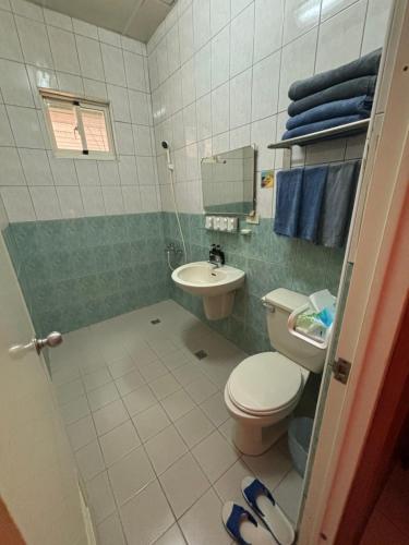 a bathroom with a toilet and a sink at Mido Hao B&B in Luye