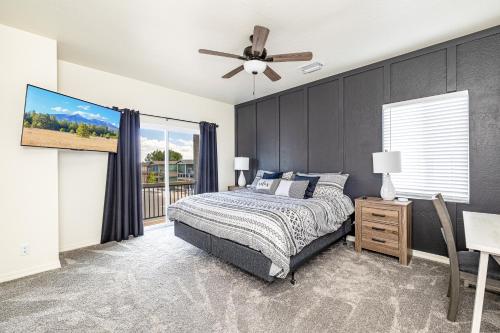 a bedroom with a bed and a ceiling fan at New Flagstaff Adventure Getaway in Flagstaff
