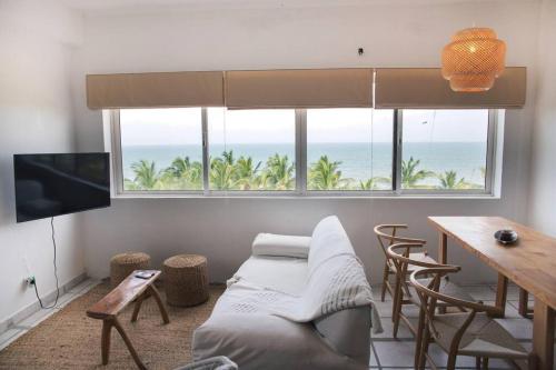 un soggiorno con divano e vista sull'oceano di Casa Mare, Tucacas 