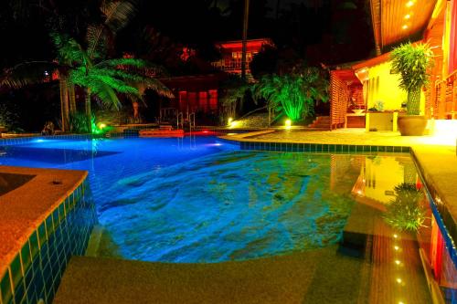 a large swimming pool at night with lights at Cyana Resort in Wok Tum