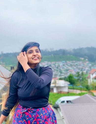 a woman standing on top of a building at The Paulwood cabana home stay in Nuwara Eliya