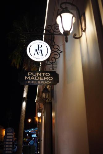 a hotel sign on the side of a building at night at Punto Madero Hotel & Plaza in Mocorito