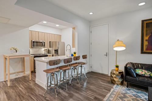 a kitchen and living room with a counter and stools at 11 Best Walk location of SM in Los Angeles