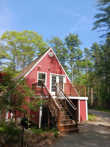 a red house with a staircase in front of it at Charming Guest House! in Exeter