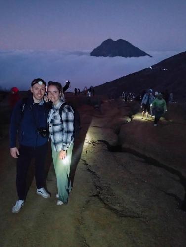 a man and woman standing on top of a mountain at Nio Homestay and Tour in Licin