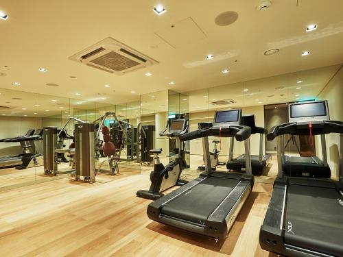 a gym with treadmills and elliptical machines and mirrors at Crown Park Hotel Seoul Myeongdong in Seoul