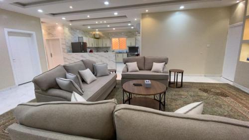 a living room with two couches and a table at مسكن الفخامة in Taif