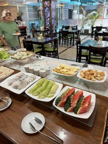 a table with several plates of food on it at Happy Light Central Nha Trang in Nha Trang