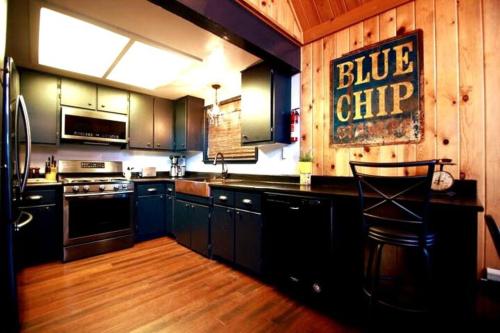 a kitchen with a blue chip sign on the wall at Glimmer Chalet Treetop A-frame cabin lake view in Lake Arrowhead