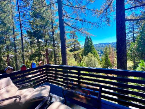 a bench with a view of a forest at Glimmer Chalet Treetop A-frame cabin lake view in Lake Arrowhead