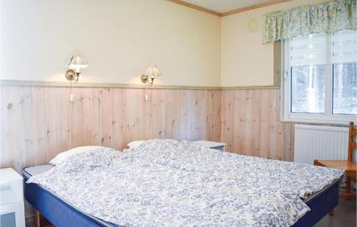 a bedroom with a bed and a window at 3 Bedroom Gorgeous Home In Holmsjö in Holmsjö