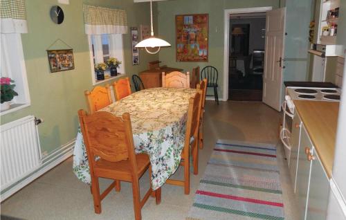 a kitchen with a table and a table and chairs at Three-Bedroom Holiday Home Brösarp 04 in Brösarp