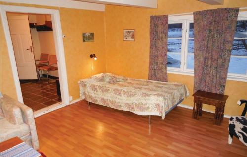 a bedroom with a bed and two windows at Three-Bedroom Holiday Home Brösarp 04 in Brösarp