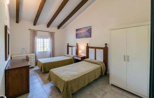 a hotel room with two beds and a cabinet at Nice Home In La Puebla De Los Infan in La Puebla de los Infantes