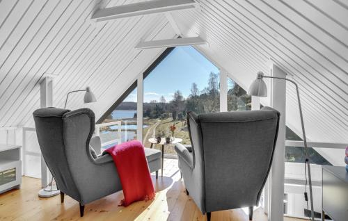 two chairs in a room with a large window at Awesome Home In Hobro With Kitchen in Hobro
