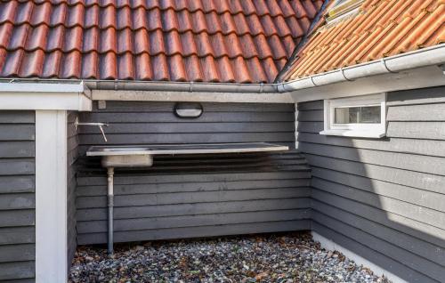 an outside corner of a house with a roof at Awesome Home In Rudkøbing With Sauna in Spodsbjerg