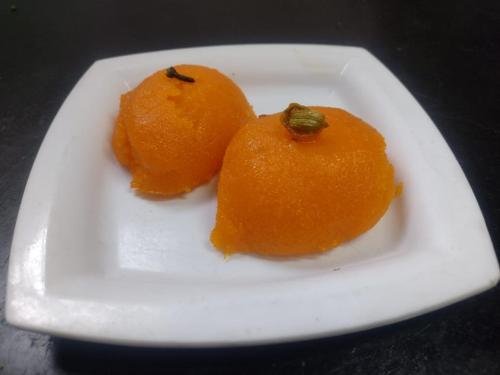 three oranges on a white plate on a table at Swanky Sojourns Homestay in Kolhapur