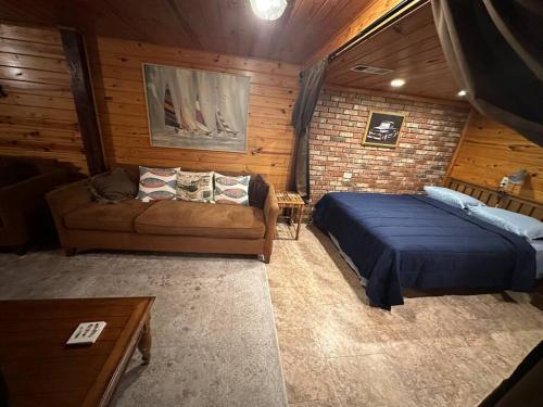 a bedroom with a bed and a couch in a room at The Beach Cave in Santa Rosa Beach