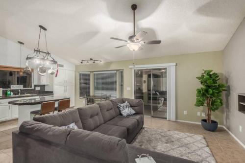 a living room with a couch and a kitchen at Gilbert oasis in Gilbert