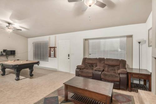 a living room with a couch and a pool table at Gilbert oasis in Gilbert