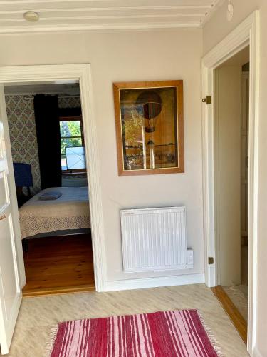 a room with a bed and a picture on the wall at Villa Wargquist in Djuras