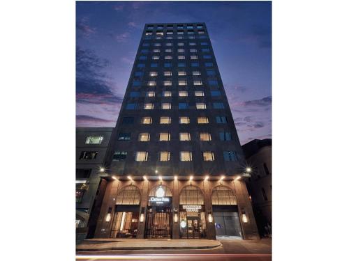 a tall building is lit up at night at Crown Park Hotel Seoul Myeongdong in Seoul