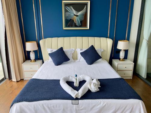 a bedroom with a bed with two heart shaped towels at 苏梅岛观景台海景別墅Golden Coconut Villa 5 超级海景 私密泳池 接送服务 in Koh Samui 