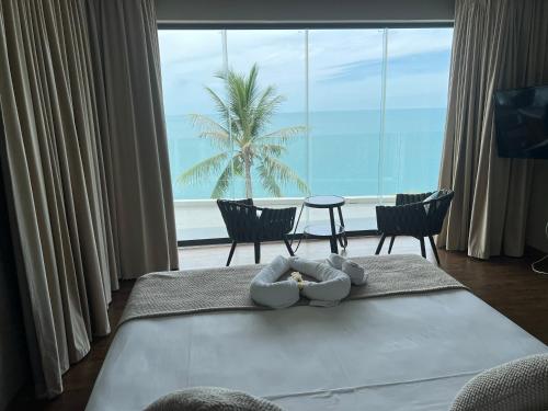 a hotel room with a bed with a view of the ocean at 苏梅岛观景台海景別墅Golden Coconut Villa 5 超级海景 私密泳池 接送服务 in Koh Samui 