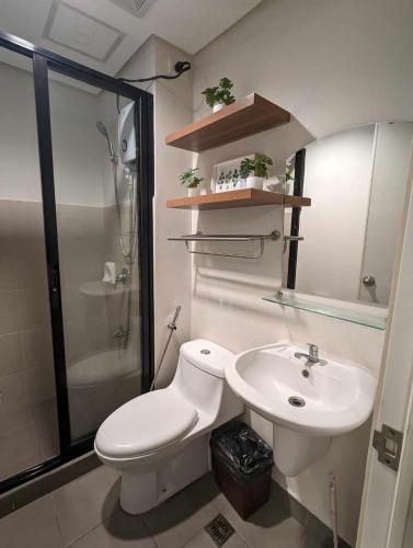 a bathroom with a toilet and a sink and a shower at Joyce Condo @ Centrio Towers in Cagayan de Oro