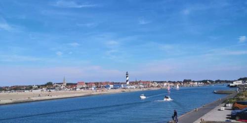 a river with boats in the water and a beach at Oasis au Chenal - Proche Plage in Grand-Fort-Philippe