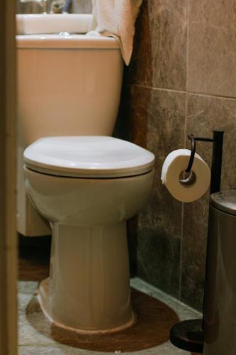 a bathroom with a white toilet and a sink at Auberge PVT Hostel in Montreal