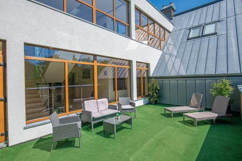 a patio with chairs and tables next to a building at Rezydencja Familia in Świnoujście