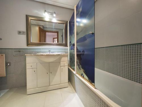 a bathroom with a sink and a mirror at Apartamento centro Nigrán in Nigrán