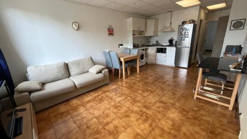 un salon et une cuisine avec un canapé et une table dans l'établissement Maison+terrasse au calme à 100m de l’eau, vue mer, à Marseille