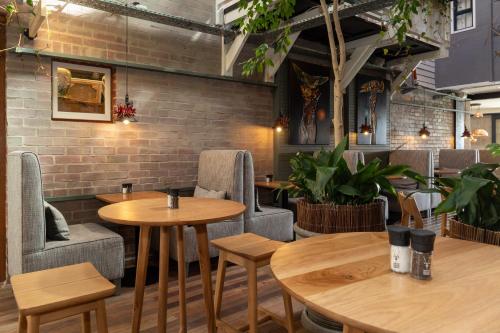 a restaurant with tables and chairs and a brick wall at The Lofts Boutique Hotel in Knysna