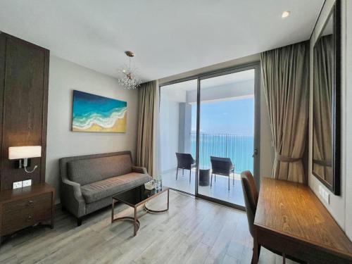 a living room with a couch and a table at Panorama Nha Trang Condotel by One in Nha Trang