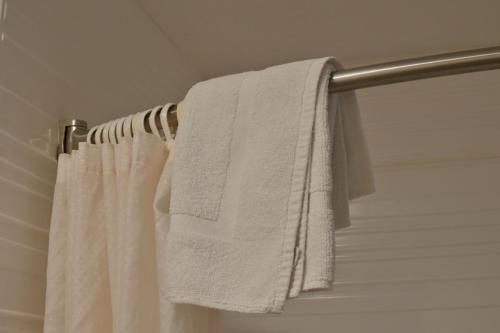 a white towel hanging on a towel rack in a bathroom at A-1 Budget Motel in Klamath Falls