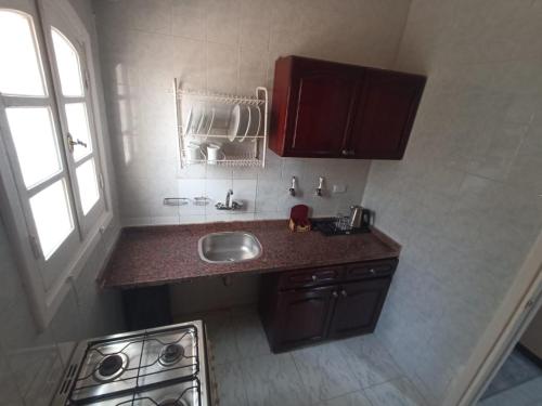 a small kitchen with a sink and a stove at El Obayed Apartments Armed Forces in Marsa Matruh