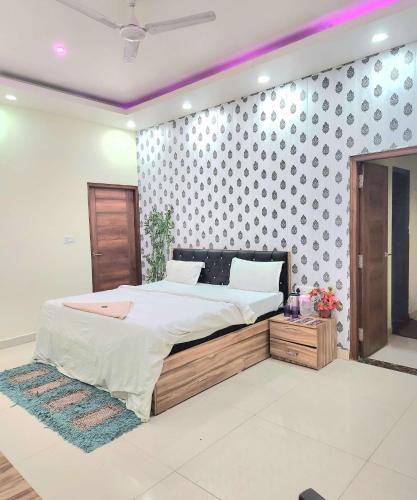 a bedroom with a bed and a wall with polka dots at Mauji's Villa Hotel & Guest House in Prayagraj