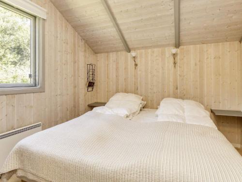 a bedroom with a white bed in a room at 4 star holiday home in Præstø-By Traum in Præstø