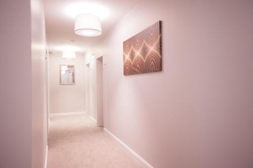 a hallway with a painting on a white wall at Hotel Rheinischer Hof Bad Soden in Bad Soden am Taunus