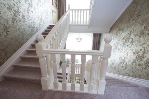 a staircase in a house with a white stair case at Hotel Rheinischer Hof Bad Soden in Bad Soden am Taunus