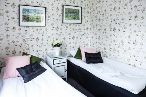 two beds sitting next to each other in a room at Bjurfors Hotell & Konferens in Avesta