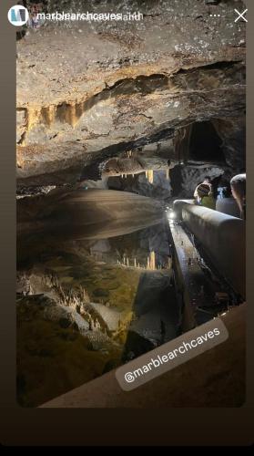 a picture of a cave with a reflection in the water at Ashwoods House in Enniskillen