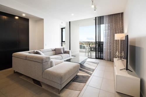 a living room with a couch and a table at CASSA OPERA - Spacious 3B Apartment in the Heart Managed by The Cassa in Brisbane